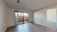 Located at 4945 Mack Rd in Sacramento, CA, this one-bedroom, one-bathroom unit offers a practical and well-appointed single-story layout. Light wood-style flooring runs throughout, creating a clean and cohesive look across all rooms.

The combined kitchen and living area forms the heart of the unit. The kitchen is efficiently designed with gray shaker-style cabinetry, granite-look countertops, white appliances including a range and refrigerator, and a stainless steel sink — all illuminated by overhead lighting. The open living area flows naturally from the kitchen and features a ceiling fan, neutral walls, and access to a private patio through a full-width sliding glass door framed by vertical blinds, offering outdoor views of surrounding greenery.

The bedroom is a comfortable, well-proportioned room featuring a large window that brings in natural light and offers exterior views. Textured ceilings add subtle architectural character to the space.

The bathroom is clean and functional, featuring a full tub-shower combination with built-in shelving, continuing the unit's consistent light and neutral color palette. Light wood-style flooring ties the bathroom seamlessly to the rest of the home.