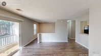 Located at 4002 Twickenham Ct in Raleigh, NC, this single-floor, 2-bedroom, 2-bathroom home offers a functional and comfortable layout. The open living and dining area is finished with rich hardwood-style flooring and neutral warm-toned walls, complemented by a textured ceiling and recessed lighting. A half-wall partition adds a subtle architectural detail that defines the living space while maintaining an open feel. Natural light filters through blinds-fitted windows throughout the home.

The kitchen is well-equipped with white shaker-style cabinetry, granite-patterned countertops, a subway tile backsplash, and hardwood-style flooring that continues from the main living area. It provides ample storage and counter workspace for everyday cooking.

Both bedrooms feature plush carpet flooring, neutral walls, and windows that allow natural light to brighten each room. Each bedroom is served by its own closet, offering practical storage solutions. The primary bedroom is generously sized and connects to a dedicated bathroom.

The two bathrooms are clean and functional, one featuring a vanity with granite-style countertops, brushed nickel fixtures, and a well-lit mirror, while the other includes a full shower/tub combination. A hallway connects the key areas of the home, ensuring a smooth and logical flow throughout.
