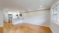 Located at 77 Cambridge Terrace in Hackensack, NJ, this well-appointed one-bedroom, one-bathroom unit offers a thoughtfully designed layout that maximizes its comfortable footprint. Warm hardwood flooring flows throughout, unifying the space with a clean, cohesive aesthetic.

The kitchen is a standout feature, showcasing white shaker cabinetry, stainless steel appliances including a gas range, built-in microwave, refrigerator, and dishwasher, all complemented by a striking marble-style granite peninsula with an undermount sink. A subway tile backsplash and floating walnut shelves add modern character, while recessed lighting keeps the space bright and functional. The kitchen opens seamlessly into the living area, which benefits from abundant natural light through large windows and a sliding door, and is finished with a ceiling fan and crown molding.

The generously sized primary bedroom offers a tranquil retreat with multiple windows framing lush outdoor views and recessed lighting overhead. An adjoining walk-in closet features built-in shelving and hanging rods, providing excellent storage.

The bathroom is finished with neutral travertine-style tile, a tub-shower combination, a dark wood vanity with a white countertop, and a mirrored medicine cabinet.