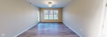 Located at 101 YMCA Way in Covington, Virginia, this single-floor residence offers a thoughtfully designed layout with a cohesive, neutral color palette throughout. The space transitions naturally between distinct living areas, each finished with materials suited to their function.

The kitchen is a standout feature, equipped with rich medium-toned wood cabinetry extending to the ceiling for generous storage capacity. Stainless steel appliances—including a full-size refrigerator and microwave—are complemented by a black electric range. White countertops provide a clean contrast, and light wood-look flooring ties the space together. A pendant light fixture and open sightlines to a breakfast bar area add to the kitchen's functionality and visual appeal.

The main living and dining areas feature durable wood-look flooring and large windows that bring in abundant natural light and outdoor views of the surrounding greenery. A decorative ceiling fixture enhances the dining area.

Bedrooms are finished with plush neutral carpeting, and several rooms include ceiling fans with lighting and windows overlooking the exterior. The layout, visible in the 3D overview, reveals a well-organized floor plan connecting living, dining, and private spaces efficiently.

Two bathrooms serve the residence. The full bath includes a tub-shower combination, tile flooring, and a wood-cabinet vanity with a white countertop. A half bath features a matching vanity and tile flooring, providing a practical option for guests.