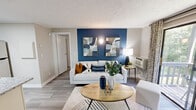 Located at 1505 Greenbrier Ridge Way in Knoxville, TN, this thoughtfully designed one-bedroom, one-bathroom residence offers a cohesive and modern aesthetic throughout its efficiently arranged single floor. The living room serves as the heart of the home, anchored by a bold navy blue accent wall adorned with contemporary artwork. Wood-style flooring runs throughout, complementing the neutral tones of the walls and textured ceiling. A sliding glass door floods the space with natural light and opens to a private balcony overlooking lush greenery, creating a seamless indoor-outdoor connection. The kitchen is well-appointed with crisp white shaker cabinets, granite countertops, stainless steel appliances including a refrigerator and dishwasher, and a skylight that adds an extra touch of brightness. The bedroom continues the bold design language with its own navy accent wall, a ceiling fan with light fixture, and a window that frames views of the surrounding foliage, contributing to a calm, nature-connected atmosphere. The bathroom features white cabinetry, a granite vanity, a framed mirror, and a shower-tub combination. A dedicated closet provides practical storage. This residence offers a refined, move-in-ready living experience with stylish modern touches throughout.