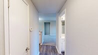 Located at 3653 Timberglen Rd in Dallas, TX, this single-story 2-bedroom, 2-bathroom home offers a clean, neutral aesthetic throughout. The layout is efficiently designed, connecting living areas, hallways, and bedrooms in a cohesive flow.

The kitchen is a functional standout, featuring white cabinetry, light stone countertops, a gray subway tile backsplash, stainless steel appliances including a range and microwave, and wood-look flooring — providing a bright, modern workspace.

Both bedrooms are carpeted and finished with neutral-toned walls, offering a calm and versatile environment. The primary bedroom is a comfortable size and is served by a dedicated bathroom. The second bedroom features a large window with blinds that invites natural light and provides views of the surrounding neighborhood greenery. Each bedroom is paired with a dedicated closet, both fitted with wire shelving systems offering practical organization.

The two bathrooms are consistent in design, each featuring a tub-shower combo with white tile surround, a curved shower rod, wood-look flooring, and overhead cabinetry for storage. One bathroom provides direct access to a walk-in closet, enhancing the functionality of the primary suite.

A sliding glass door in the living area, dressed with vertical blinds, connects the interior to the outdoors and fills the space with natural light.