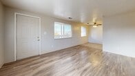 This 610 square foot apartment in Wheat Ridge, CO offers a thoughtful blend of comfort and functionality. The single-story layout comprises two bedrooms, one bathroom, and an open-concept living area. Upon entering, you're greeted by a bright living room with large windows that flood the space with natural light. The flooring transitions seamlessly from durable wood-look laminate in the main living areas to plush carpeting in the bedrooms.

The kitchen, while compact, is efficiently designed with ample wooden cabinetry, a full-sized refrigerator, and essential appliances. The bathroom features a clean, modern aesthetic with a white tiled shower/tub combination and a single vanity. 

The primary bedroom, measuring 140 square feet, offers a cozy retreat with a large window and a spacious closet. The second bedroom, though smaller, provides versatility as a guest room or home office. Both bedrooms feature neutral-toned carpeting and ample natural light.

Throughout the apartment, the neutral color palette and textured walls create a blank canvas for personal style. Ceiling fans in the living area provide additional comfort. The apartment's layout maximizes the use of space, making it an ideal choice for those seeking a low-maintenance yet comfortable living environment in a convenient Wheat Ridge location.