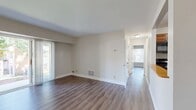This 700 square foot apartment offers a well-designed living space with two bedrooms and one bathroom. The primary bedroom is generously sized at 190 square feet, providing ample space for comfort. Throughout the apartment, modern vinyl plank flooring creates a cohesive and contemporary look.

Large windows in the living areas and bedrooms allow for abundant natural light, creating a bright and airy atmosphere. The open-concept living and dining area seamlessly connects to the kitchen, ideal for entertaining or everyday living. The kitchen features wooden cabinetry, black appliances, and a practical layout for meal preparation.

The bathroom is equipped with a full-sized bathtub and shower combination, complete with built-in shelving for added convenience. In-unit laundry facilities are discreetly tucked away behind closet doors, maximizing living space.

Storage is plentiful with closets in the bedrooms and throughout the apartment. The neutral color palette of the walls provides a blank canvas for personalization. Located in the Commons At Windsor Gardens community, this apartment combines functionality with modern comforts in a compact yet efficiently designed space.
