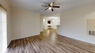 This single-story home in Glen Allen, Virginia offers 1180 square feet of living space with a practical and modern layout. The property boasts five bedrooms, including a generous 170 square foot primary bedroom, and two full bathrooms. The heart of the home is an open-concept area combining the kitchen and living room, creating a spacious and inviting atmosphere.

The kitchen features dark wood cabinetry, granite countertops, and stainless steel appliances, including a refrigerator, dishwasher, and built-in microwave. A breakfast bar adds extra seating and separates the kitchen from the living area. Throughout the home, wood-look laminate flooring adds warmth and durability to high-traffic areas.

Bedrooms are carpeted for comfort, with the primary bedroom offering ample space and a ceiling fan. Bathrooms are equipped with modern fixtures, including a combination tub-shower with safety bars. Large windows and vertical blinds allow for natural light and privacy control.

The property's neutral color palette and clean lines create a contemporary feel, while ceiling fans in main living areas provide air circulation. Ample closet space, including walk-in closets, offers plenty of storage. The home's layout promotes easy flow between rooms, making it ideal for both everyday living and entertaining.