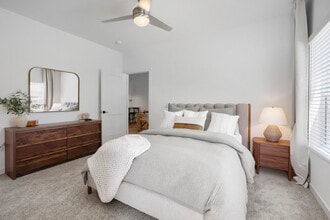 The B2 primary bedroom's vaulted ceiling and oversized windows set it apart from standard Chandler apartments. - Garrett Uptown Apartments