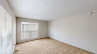 This single-floor, one-bedroom, one-bathroom residence in Baton Rouge, Louisiana, offers a practical and straightforward layout well-suited for individuals or couples. The living area is finished with wall-to-wall beige carpeting and neutral-toned walls, creating a blank canvas for personalization. Multiple windows fitted with horizontal blinds allow natural light to filter into the space, contributing to an open and airy feel. A textured popcorn ceiling is consistent throughout the carpeted areas, while a ceiling fan in the bedroom provides added comfort and air circulation.

The galley-style kitchen features white cabinetry with ample upper and lower storage, light-toned countertops, a double stainless steel sink, and wood-look flooring. White appliances, including a refrigerator and range, are included. The kitchen's layout maximizes efficiency within a compact footprint.

The bedroom offers a comfortable amount of space, with carpeted flooring, a large window for natural light, a ceiling fan, and a dedicated HVAC vent for climate control.

The bathroom includes a full tub and shower combination with white surround, a toilet, and a vanity with light countertops and white cabinetry, all set on wood-look flooring. The overall design is clean, functional, and move-in ready.