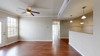 Located at 1000 Willow Oak Ln in Jackson, TN, this 2-bedroom, 2-bathroom residence offers a thoughtfully designed single-floor layout that balances comfort and functionality. The open-concept living room features rich hardwood flooring, crown molding, a ceiling fan, and access to an outdoor balcony through a glass-paneled door, filling the space with natural light. The kitchen flows seamlessly from the living area and is highlighted by granite countertops, dark espresso cabinetry, stainless steel appliances, a double-basin sink, and elegant pendant lighting overhead. Both bedrooms are finished with plush carpet and ceiling fans. The primary bedroom offers a generous footprint with a walk-in closet equipped with built-in wire shelving. The second bedroom features a large window that invites ample natural light. The two bathrooms are finished with tile flooring and dark-toned vanity cabinetry with granite counters; one includes a soaking tub and shower combination. A dedicated closet provides additional storage throughout the unit. Neutral tones, consistent finishes, and a well-connected floor plan create a cohesive and welcoming living environment throughout this Jackson, TN residence.