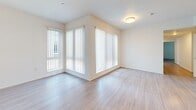 Located at 4340 44th Street in San Diego, CA, this 2-bedroom, 2-bathroom residence offers a thoughtfully designed single-floor layout with a clean, modern aesthetic throughout. Light wood-tone flooring runs consistently across the living areas and bedrooms, creating a cohesive and airy feel. Large windows dressed with vertical blinds bring in generous natural light, enhancing the bright, neutral palette of white and warm beige walls.

The open kitchen and living area form the heart of the home. The kitchen features white upper cabinetry, textured lower cabinets, a stainless steel refrigerator, an electric range, and recessed lighting overhead — offering both functionality and a contemporary look. The adjacent living area is spacious and versatile, with ample room for various furniture arrangements.

Both bedrooms are comfortably sized, with the primary bedroom offering notably generous dimensions. Each bedroom benefits from natural light through large windows. The two bathrooms are finished consistently with wood-tone cabinetry, white countertops, and a tub-shower combination, providing a clean and practical design.

The overall ambiance of the home is bright, open, and move-in ready, with a neutral design palette that accommodates a wide range of personal styles. The well-organized floor plan maximizes the available space efficiently throughout.