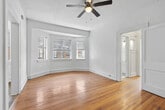 This 2-bedroom, 1-bathroom residence in Birmingham, Alabama offers a practical and comfortable layout across a single floor. Warm hardwood flooring flows throughout the living areas and bedrooms, lending a classic, cohesive feel to the space. Each room is fitted with a ceiling fan, providing both comfort and light.

The primary bedroom is notably spacious, featuring a charming bay window arrangement that draws in abundant natural light and offers views of the surrounding exterior. A second bedroom also benefits from natural light via a single window with a pleasant outdoor view. Both bedrooms include closets and display the same rich hardwood floors.

The kitchen is efficiently designed with white cabinetry, a wood-toned countertop, a stainless steel sink, a gas range, and a full-size refrigerator. Light wood-style flooring completes the clean, functional look of the kitchen space.

The bathroom is finished in a crisp, all-white palette, featuring classic hexagonal tile flooring, a tub-shower combination with white tile surround, and a window that allows natural light to brighten the space.

A hallway connects the rooms, contributing to a logical and easy-to-navigate floor plan. Throughout the residence, white walls and natural light create a bright, airy ambiance that complements the warm tones of the hardwood floors.