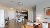 Located at 131 E Bardin Rd in Arlington, Texas, this well-appointed single-story residence offers a thoughtfully designed open-concept layout with modern finishes throughout. The kitchen serves as a central highlight, featuring rich dark espresso cabinetry, granite countertops, stainless steel appliances including a refrigerator, microwave, and range, and a kitchen island with bar seating for two — ideal for casual dining and entertaining. Wood-style flooring flows seamlessly through the main living areas, adding warmth and continuity to the space. The living room is bright and welcoming, with natural light filtering through large windows dressed with draping curtains and a ceiling fan overhead. The bedrooms are comfortably sized, each with plush carpeting, natural window light, ceiling fans, and ample wall space. The primary bathroom is generously proportioned, offering a dual-sink vanity with granite countertops, dark cabinetry, wood-style flooring, and a glass-enclosed shower. A walk-in closet with built-in shelving connects directly to the primary bath, providing excellent storage. Throughout the residence, neutral wall tones and consistent finishes create a cohesive, contemporary aesthetic well-suited for modern living.