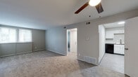 Located at 5020 Chatterton Rd in Columbus, Ohio, this single-floor residence offers a well-organized and functional layout throughout. The living area is generously proportioned, featuring soft wall-to-wall carpeting, neutral gray walls, and a ceiling fan that contributes to year-round comfort. Large windows allow natural light to fill the space, creating a bright and welcoming atmosphere. The open flow of the floor plan connects the living area seamlessly to adjacent rooms, as visible in the dollhouse overview.

The kitchen is outfitted with crisp white cabinetry, granite-style countertops, and black appliances including a gas range, over-the-range microwave, and refrigerator. The hard flooring in the kitchen provides a practical contrast to the carpeted living and sleeping areas.

The bedroom is spacious with its own ceiling fan, plush carpeting, and a large window with blinds that invite natural light while maintaining privacy. Closet access is conveniently located within the room.

The bathroom is finished with wood-look vinyl flooring, a full tub and shower surround in bright white, brushed nickel fixtures and towel bars, and a vanity with ample counter space. The overall design throughout the unit is clean, neutral, and move-in ready.