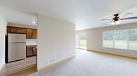 Located at 3275 40th Ave S in Saint Cloud, Minnesota, this two-story home offers a well-designed layout spread across two floors of comfortable living space. The main level features an open-concept living, dining, and kitchen area with durable hardwood-style flooring that flows seamlessly throughout. The kitchen is a standout, showcasing rich dark cabinetry, light granite-style countertops, stainless steel appliances including a built-in microwave and dishwasher, and a double-basin sink. A pendant chandelier and recessed lighting add warmth, while a sliding glass door opens to outdoor views, filling the space with natural light. The living area is carpeted and connects effortlessly to the dining space. The main level also includes an attached garage with an automatic opener. Upstairs, the generously sized primary bedroom features carpet flooring, a ceiling fan, and a large closet. The second bedroom is equally well-appointed with carpet and its own closet. Three bathrooms serve the home, including one with a full soaking tub and shower combo alongside built-in shelving. A dedicated laundry area and four closets throughout round out the practical features of this clean, move-in-ready home.
