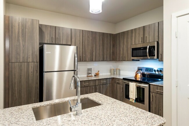 Kitchen with Stainless Steel Appliances - The Henry at Lake Houston