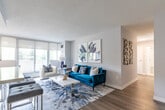 Located at 3620 Kaneff Crescent in Mississauga, this thoughtfully designed 2-bedroom, 1-bathroom residence offers a clean, contemporary aesthetic across a single floor. The layout flows efficiently through two hallways, connecting each room with ease.

The kitchen is a functional highlight, featuring crisp white cabinetry with modern hardware, a white tile backsplash, light wood-tone flooring, and a full suite of stainless steel appliances including a refrigerator, stove, built-in microwave, and dishwasher. Recessed lighting brightens the space throughout.

The open dining area sits adjacent to the kitchen, bathed in natural light from large windows framed by greenery outside — a recurring feature across the unit that brings a refreshing sense of nature indoors.

Both bedrooms are comfortably sized with neutral grey tones, sliding closet doors, and generous windows overlooking lush treetops. The primary bedroom offers a wide window wall with roller blinds and ample room for a full bedroom suite.

The bathroom is finished in a clean, minimal style with a undermount sink, sleek chrome fixtures, a large mirror, and light quartz countertops, contributing to the overall modern tone of the space.

Warm wood-look flooring runs throughout the main living areas, tying together the cohesive, updated design of this well-maintained Mississauga residence.
