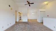 Located at 3527 Lakeshore Rd in Sheboygan, Wisconsin, this single-floor unit offers a well-organized layout with a variety of functional spaces. The open living area is a standout, boasting soaring vaulted ceilings, a ceiling fan, and plush wall-to-wall carpeting. An elegant chandelier illuminates the adjoining dining area, which connects seamlessly to the rest of the space. Natural light pours in through a set of classic French doors that lead to an outdoor area, enhancing the bright and airy atmosphere throughout. The galley-style kitchen is efficiently designed with cream cabinetry trimmed in wood, a full suite of appliances including a gas range, dishwasher, and refrigerator, as well as tile flooring and ample counter space. Two generously sized bedrooms, each carpeted and featuring windows that bring in natural light, offer comfortable retreats. The primary bedroom includes access to a spacious walk-in closet with built-in shelving and hanging rods, providing excellent storage. Two bathrooms serve the unit, one featuring a soaking tub and the other a clean, tile-floored layout with a vanity. The overall aesthetic is clean and neutral, offering a versatile canvas throughout.