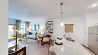 This thoughtfully designed one-bedroom, one-bathroom unit in Georgetown, TX offers a cohesive open-concept layout that maximizes its efficient footprint. The kitchen serves as a central highlight, featuring granite countertops, a large peninsula with bar seating, pendant lighting, stainless steel appliances, and a combination of white upper and gray lower cabinetry. Light wood-style flooring flows seamlessly from the kitchen into the dining and living areas, enhancing the sense of continuity.

The living room is bright and welcoming, benefiting from multiple windows with natural light and access to an exterior door. The space accommodates comfortable seating and is finished with neutral walls that complement the warm flooring.

The bedroom is a well-sized retreat equipped with a ceiling fan, large windows with blinds, and soft carpet flooring. A closet provides practical storage within the room.

The bathroom is cleanly finished with tile flooring, a granite-topped vanity with gray cabinetry, a tub-shower combination, and contemporary fixtures. Overall, the unit presents a modern, cohesive aesthetic with quality finishes throughout.