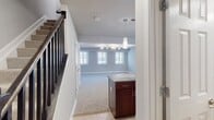 This 1040 square foot townhouse in Arbor Park of Alexandria offers a well-designed living space across two floors. The property features 2 bedrooms, including a primary bedroom of 180 square feet, and 3 bathrooms, providing ample space and privacy.

The interior is characterized by modern finishes and neutral tones, creating a bright and inviting atmosphere. Plush carpeting in the bedrooms and living areas contrasts with tiled flooring in the kitchen and bathrooms. Large windows throughout allow for abundant natural light, enhancing the sense of spaciousness.

The kitchen is equipped with stainless steel appliances, dark wood cabinetry, and granite countertops, offering both functionality and style. A central island provides additional counter space and storage. The bathrooms feature clean lines with beige tiled walls and modern fixtures.

Ceiling fans in the bedrooms add to the comfort, while recessed lighting and pendant fixtures provide layered illumination. The property also includes a hallway and closet space for additional storage.

The two-story layout, connected by a staircase with an elegant banister, offers a clear separation between living and sleeping areas. With its thoughtful design and quality finishes, this townhouse presents a comfortable and contemporary living solution in a desirable Alexandria location.