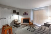 Located at 695 Pineloch Dr in Houston, TX, this single-story residence offers a well-designed layout that balances comfort and functionality. The living area serves as the heart of the home, highlighted by a classic brick fireplace and wood-look flooring that extends throughout the main living spaces. A sliding glass door fills the room with natural light and provides direct access to a private patio. The open-concept design connects the living area to a breakfast bar, creating a seamless flow into the kitchen. The galley-style kitchen is outfitted with dark espresso cabinetry, granite-style countertops, and black appliances, offering ample storage and a clean, modern aesthetic. The space accommodates two well-proportioned bedrooms, each carpeted and equipped with ceiling fans and windows that invite natural light. The primary bathroom features a dark vanity with a granite-style countertop and a tiled tub surround, while the second bathroom offers a shower-tub combination. Throughout the home, neutral tones and consistent finishes create a cohesive and inviting atmosphere, making this Houston residence a practical and comfortable place to call home.