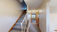 Located at 2025 Applegrove St NW in North Canton, Ohio, this three-bedroom, three-bathroom home spans three floors, offering a well-distributed and functional layout throughout. The main level features a carpeted living room filled with natural light from wood-trimmed windows, a dedicated dining room, and a kitchen equipped with warm oak cabinetry, tile flooring, and white appliances, including a refrigerator and range. Two hallways connect the main living areas efficiently, enhancing the flow of the home. Each of the three bedrooms is carpeted and features wood-trimmed doors, with the generously sized primary bedroom offering a comfortable, private retreat with closet access. The three bathrooms are clean and practical, with one full bath featuring tile flooring, a sliding glass-door shower stall, and a vanity. A second bath provides a simple, functional powder room layout. The basement level adds considerable versatility, with one finished room showcasing rich wood-paneled walls, carpet flooring, and a textured ceiling, ideal as a recreation or bonus room. A second unfinished basement area houses utilities, including the water heater and HVAC system, with a painted concrete floor and open-beam ceiling offering ample storage potential. A staircase connects all three levels, completing this well-rounded home.