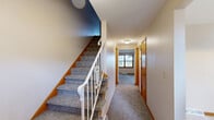 Located at 2025 Applegrove St NW in North Canton, Ohio, this three-bedroom, three-bathroom home spans three floors, offering a well-distributed and functional layout throughout. The main level features a carpeted living room filled with natural light from wood-trimmed windows, a dedicated dining room, and a kitchen equipped with warm oak cabinetry, tile flooring, and white appliances, including a refrigerator and range. Two hallways connect the main living areas efficiently, enhancing the flow of the home. Each of the three bedrooms is carpeted and features wood-trimmed doors, with the generously sized primary bedroom offering a comfortable, private retreat with closet access. The three bathrooms are clean and practical, with one full bath featuring tile flooring, a sliding glass-door shower stall, and a vanity. A second bath provides a simple, functional powder room layout. The basement level adds considerable versatility, with one finished room showcasing rich wood-paneled walls, carpet flooring, and a textured ceiling, ideal as a recreation or bonus room. A second unfinished basement area houses utilities, including the water heater and HVAC system, with a painted concrete floor and open-beam ceiling offering ample storage potential. A staircase connects all three levels, completing this well-rounded home.