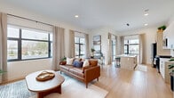 Located at 365 Terhune in Princeton, NJ, this thoughtfully designed two-bedroom, two-bathroom residence offers a clean, modern aesthetic across a single, well-organized floor. Light hardwood flooring flows throughout the open-concept living areas, anchoring a bright and airy atmosphere enhanced by large black-framed windows that invite abundant natural light.

The combined kitchen and living room serves as the heart of the home. The kitchen features a central island with a sink, light wood cabinetry paired with white upper cabinets, stainless steel appliances, and a gas range — all opening seamlessly to the dining and living areas. Floor-to-ceiling glass doors lead to a private balcony, extending the living space outdoors.

The spacious primary bedroom offers a serene retreat with generous proportions, a large closet with built-in shelving, and a dedicated en-suite bathroom complete with a frameless sliding glass shower with floor-to-ceiling tile and matte black fixtures. The second bedroom is equally well-appointed, featuring large windows with outdoor views and plush carpeting. A second full bathroom includes a white vanity and neutral tile flooring.

Additional conveniences include a pantry, in-unit laundry, and three closets providing ample storage throughout.