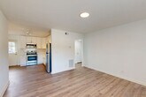 Located at 1050 Villa Ct SE in Atlanta, GA, this single-floor, 2-bedroom, 1-bathroom home offers a well-organized and efficiently designed layout. The open-concept living and kitchen area is anchored by durable hardwood-style flooring and clean white walls, creating a bright and welcoming atmosphere. The kitchen is well-appointed with white shaker cabinetry, a subway tile backsplash, stainless steel appliances including a refrigerator, range, microwave, and dishwasher, and track lighting overhead. A window at the far end of the living area allows natural light to fill the space.

Both bedrooms feature plush carpeting, ceiling fans with integrated lighting, and windows with blinds that provide views of the surrounding greenery. The spacious primary bedroom includes a dedicated closet, offering practical storage. A hallway connects the main living areas to the bedrooms and bathroom.

The bathroom is thoughtfully finished with classic white subway tile surrounding the tub and shower, penny tile flooring, a white vanity, and a window that brings in natural light. A closet provides additional storage within the unit. Overall, the home presents a clean, modern aesthetic with functional design elements throughout.