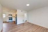 Located at 1050 Villa Ct SE in Atlanta, GA, this single-floor, 2-bedroom, 1-bathroom home offers a well-organized and efficiently designed layout. The open-concept living and kitchen area is anchored by durable hardwood-style flooring and clean white walls, creating a bright and welcoming atmosphere. The kitchen is well-appointed with white shaker cabinetry, a subway tile backsplash, stainless steel appliances including a refrigerator, range, microwave, and dishwasher, and track lighting overhead. A window at the far end of the living area allows natural light to fill the space.

Both bedrooms feature plush carpeting, ceiling fans with integrated lighting, and windows with blinds that provide views of the surrounding greenery. The spacious primary bedroom includes a dedicated closet, offering practical storage. A hallway connects the main living areas to the bedrooms and bathroom.

The bathroom is thoughtfully finished with classic white subway tile surrounding the tub and shower, penny tile flooring, a white vanity, and a window that brings in natural light. A closet provides additional storage within the unit. Overall, the home presents a clean, modern aesthetic with functional design elements throughout.