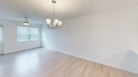 Located at 32015 Azure Ave in Rehoboth Beach, Delaware, this single-floor, 2-bedroom, 2-bathroom residence offers a clean, modern interior designed for comfortable coastal living. Light wood-style flooring runs throughout the main living areas, complementing the bright white walls and creating a fresh, airy atmosphere.

The kitchen is well-appointed with rich, dark-toned cabinetry, stainless steel appliances including a range, microwave, and refrigerator, and a white countertop with an undermount sink. Pendant lighting adds a polished finishing touch. Adjacent to the kitchen, the dining area features light-filled windows and an elegant brass chandelier.

Both bedrooms are carpeted and include ceiling fans and natural light from blinds-fitted windows. The primary bedroom also features a wall-mounted mini-split system for independent climate control. Two closets provide dedicated storage throughout the unit.

The bathrooms are finished with dark wood vanities and white countertops. One bathroom includes a glass-enclosed walk-in shower, while the second offers a full soaking tub. Both maintain a clean, consistent aesthetic with light wood-style flooring.

A dedicated in-unit laundry area houses a full-sized washer and dryer with overhead shelving. The entry hallway features brass wall hooks, offering a practical and welcoming arrival experience.