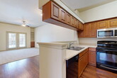 This 850 square foot apartment in Lewisville, TX offers a thoughtful layout with 2 bedrooms and 2 bathrooms. The primary bedroom spans 160 square feet, providing a spacious retreat. The interior showcases a blend of hardwood flooring in the living areas and plush carpeting in the bedrooms, creating a harmonious mix of style and comfort.

The well-designed kitchen features wooden cabinetry, modern appliances including a microwave and oven, and a convenient breakfast bar that opens to the living area. Large windows throughout the apartment allow for abundant natural light, enhancing the sense of space and airiness.

Both bathrooms are outfitted with essential fixtures, including bathtub-shower combinations and vanities with storage. The apartment also includes two closets for ample storage solutions. A notable feature is the private outdoor access via French doors in one of the rooms, likely the living area or primary bedroom.

The property's layout is designed for easy flow between rooms, with an open concept connecting the kitchen and living spaces. Ceiling fans are installed to aid in air circulation and comfort. This apartment offers a balanced combination of functionality and comfort, ideal for those seeking a well-appointed living space in the Lewisville area.