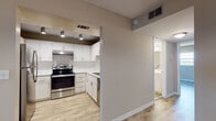 Located at 17105 Gulf Blvd in North Redington Beach, Florida, this single-floor unit offers a clean, modern interior with a cohesive design throughout. The kitchen is well-appointed with white shaker-style cabinetry, stainless steel appliances including an electric range with overhead ventilation, a tile backsplash, and ample counter and storage space. Track lighting illuminates the workspace, adding both functionality and style.

The living areas are finished with wood-look luxury vinyl plank flooring in warm neutral tones, complemented by light beige walls and white baseboards that create a bright and welcoming atmosphere. Multiple windows fitted with horizontal blinds allow natural light to flow through the space. The textured ceilings add a classic touch found throughout.

The bedroom features dual bi-fold closets, providing generous storage capacity, while additional rooms offer flexible, open layouts suitable for various configurations. The bathroom is outfitted with a white vanity with modern hardware, a large mirror, a tub-shower combination, and matching wood-look tile flooring that ties the space together cohesively.

Overall, the unit presents a fresh, move-in-ready environment with updated finishes, situated in the desirable North Redington Beach coastal community along the Gulf Coast of Florida.