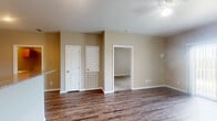 Located at 100 McNatt Dr in Brookland, Arkansas, this one-bedroom, one-bathroom unit offers a well-organized and functional single-floor layout. The open-concept living and kitchen area serves as the heart of the home, featuring rich hardwood-style flooring that adds warmth throughout. A ceiling fan provides comfort overhead, while a sliding glass door floods the living space with natural light and provides access to a private patio with outdoor views.

The kitchen is well-appointed with rich cherry-toned cabinetry, granite-style countertops, tile flooring, and black appliances including a refrigerator, range, and microwave — offering ample storage and prep space in a galley-style configuration.

The bedroom is generously sized, carpeted for comfort, and equipped with a ceiling fan and a window dressed with vertical blinds that invite natural light. It connects to a walk-in closet outfitted with wire shelving and hanging rods, providing practical and organized storage. The full bathroom features tile flooring, a tub/shower combination, and overhead cabinetry for additional storage.

Neutral wall tones and clean white trim throughout create a cohesive, move-in-ready aesthetic. This thoughtfully designed unit delivers efficient use of space with comfortable, everyday livability.