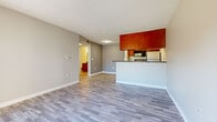 Located at 5175 Cinderlane Pkwy in Orlando, FL, this single-floor, one-bedroom, one-bathroom unit offers a practical and well-organized layout. The combined living room and kitchen area forms the heart of the home, featuring light gray laminate flooring throughout and neutral gray walls that create a clean, modern aesthetic. A textured ceiling adds character to the space.

The kitchen is defined by warm-toned wood cabinetry, dark granite countertops, and a peninsula that doubles as a breakfast bar. Stainless steel appliances, including a range and refrigerator, along with a built-in microwave, complete the functional cooking space.

The living area benefits from natural light and provides direct access to a private outdoor patio through a sliding glass door, offering pleasant views of the surrounding greenery and community.

The bedroom is a comfortable, well-proportioned space with large windows that bring in abundant natural light and overlook the outdoor landscaping. It is complemented by a dedicated closet and connects via a hallway to the full bathroom.

The bathroom features tile flooring, a granite-topped wood vanity, a white tiled tub-and-shower combination, and a large mirror — providing a clean and functional design. A hallway connects all areas of the unit efficiently, completing this thoughtfully arranged single-level home.