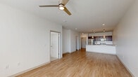 Located at 8681 Edison Plaza Dr in Fishers, Indiana, this 1-bedroom, 1-bathroom residence offers a clean, modern aesthetic with a thoughtfully designed single-floor layout. The open-concept kitchen and living area serves as the heart of the home, anchored by a large island with a white quartz countertop, undermount sink, and stylish pendant lighting overhead. Rich dark-cabinetry contrasts beautifully with the white subway tile backsplash, while stainless steel appliances — including a refrigerator, range, and microwave — complete the kitchen. Light-toned hardwood-style flooring flows throughout the main living areas, enhancing the bright, airy ambiance created by white walls and recessed lighting. A ceiling fan in the living area adds both comfort and style. The bedroom is a comfortable retreat featuring plush carpet, a ceiling fan, and a window with blinds that invites natural light. Three closets provide generous storage throughout the residence. The bathroom is finished with wood-style flooring and a walk-in shower clad in classic white subway tile with a sliding glass enclosure. A utility room and hallway round out the functional layout of this well-appointed Fishers residence.