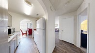 Located at 4870 Nellis Oasis Lane in Las Vegas, NV, this single-floor, 1-bedroom, 2-bathroom residence offers a practical and well-designed layout. Wood-look flooring flows throughout the main living areas, complemented by textured ceilings and a warm, neutral color palette. Charming arched doorways serve as a distinctive architectural detail, connecting the kitchen and hallway areas with character.

The combined living and dining area is bright and open, with a sliding glass door in the living room allowing natural light and outdoor views. The adjacent dining space features its own window, enhancing the sense of airiness. A ceiling fan adds comfort to the dining area.

The galley-style kitchen is efficiently arranged with granite-look countertops, gray cabinetry, a gas range, and ample storage overhead. A dedicated closet provides additional storage within the unit.

The spacious primary bedroom is carpeted for comfort and features a window with natural light, an arched entryway, and a textured ceiling. The two bathrooms include one with a wide vanity featuring dual sinks, generous counter space with granite-look surfaces, gray cabinetry, a bathtub-shower combination, and wood-look flooring — offering both style and functionality throughout.