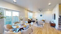 This two-story home in Loveland, Colorado offers a thoughtfully designed layout spread across two floors. The main level features an open-concept living, dining, and kitchen area filled with natural light from large windows and a sliding glass door that leads to an outdoor patio. The living room is outfitted with light hardwood-style flooring, recessed lighting, and a ceiling fan, creating a bright and comfortable gathering space. The kitchen is a standout, featuring grey shaker-style cabinetry, white quartz countertops, a classic subway tile backsplash, a central island with bar seating, and a full suite of stainless steel appliances including a gas range, microwave, and French door refrigerator. A dedicated laundry room with full-size washer and dryer is also conveniently located on the main level. The upper floor hosts all four bedrooms, each carpeted and naturally lit through window blinds. The primary bedroom offers a generous footprint with its own closet. The four bathrooms are well-appointed, with at least one featuring a dual-sink vanity with white countertops, grey cabinetry, wood-look tile flooring, and a shower-tub combination. Each bedroom includes its own closet, providing ample storage throughout the home.