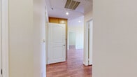 Located at 15305 Lanark St in the Van Nuys neighborhood of Los Angeles, this single-floor, 2-bedroom, 2-bathroom home offers a practical and well-organized layout. Warm hardwood-style flooring runs consistently throughout every room, creating a cohesive and inviting atmosphere.

The kitchen is efficiently designed with ample honey-toned wood cabinetry extending to the ceiling for generous storage, granite-style countertops, and a full suite of white appliances including a refrigerator, electric range, and dishwasher. The space is functional and neatly arranged.

Both bedrooms are bright and neutrally finished with soft beige walls, large windows fitted with horizontal blinds that allow for natural light and privacy control, and clean white trim and baseboards. The primary bedroom includes a closet with arched panel doors and direct access to a bathroom. The second bedroom offers a similarly open, versatile layout.

The two bathrooms are consistently finished with light wood vanities topped with granite-style countertops. One bathroom features a tub-shower combination with sliding glass doors, while the other is appointed with a single vanity and mirror. Hardwood-style flooring continues into both bathrooms, reinforcing the home's unified design aesthetic.