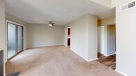 Located at 98 Oak St in Lindenwold, NJ, this two-story home offers a well-organized layout across both levels. The main floor features a spacious living room with plush carpeting, a wood-burning fireplace with glass doors, and generous natural light from a large window. Adjacent to the living area is a compact kitchen outfitted with rich, dark wood cabinetry, light stone-patterned countertops, a stainless steel gas range, over-the-range microwave, and a stainless steel sink — all set atop wood-look flooring. A half bathroom on this level includes a wood-vanity with a white basin, a framed mirror, and wood-look tile flooring. A carpeted staircase with white railings leads to the upper level, where multiple bedrooms are found. Each bedroom features neutral carpet, soft neutral wall tones, and adequate natural light. One bedroom includes a ceiling fan with light fixture, while another offers a double sliding-door closet. The upper level also includes a full bathroom with a tub-shower combination and clean white surround. Throughout the home, textured ceilings, neutral wall tones, and consistent finishes create a cohesive and functional living environment.