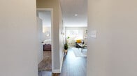 Located at 914 W Lake St in Fort Collins, Colorado, this one-bedroom, one-bathroom unit offers a practical and well-organized layout across a single floor. The open-concept living room and kitchen area forms the heart of the home, with wood-look flooring, a large window with vertical blinds that brings in generous natural light, and a wall-mounted A/C unit. The living area provides ample space for seating and entertainment, while the adjacent kitchen features gray lower cabinetry, white upper cabinets, a black range, a dishwasher, and a double sink — a functional galley-style setup ideal for everyday cooking. The bedroom is carpeted for warmth and comfort, features a window with vertical blinds, a closet with double doors, and offers enough room for a bed and a workspace. The bathroom includes a dark granite-topped vanity with gray cabinetry, a large mirror, wood-look flooring, and a shower/tub combo. Neutral tones and a textured ceiling are consistent throughout the unit, lending a clean, cohesive aesthetic. This unit is a well-appointed option for those seeking a compact, efficiently designed home in Fort Collins.