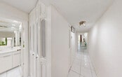 Located at 3720 Inverrary Dr in Lauderhill, Florida, this efficiently designed studio offers a well-organized single-floor layout that maximizes every square foot. The main living area seamlessly integrates sleeping, dining, and living functions into one open space, finished with gleaming white large-format tile flooring throughout. A ceiling fan with built-in lighting anchors the room, while recessed lighting along the perimeter adds a polished, modern touch. Large sliding glass doors flood the space with natural light and frame a verdant, tree-lined outdoor view, creating a refreshing sense of openness and connection to nature.

The kitchen is accessible via a pass-through window, offering a practical and space-conscious design. A bright, white-tiled hallway lined with four generously sized closets provides exceptional storage capacity, a notable feature for a studio layout. The bathroom is fully tiled in crisp white marble-look tile from floor to ceiling, equipped with a wide vanity, a large wall mirror, recessed lighting, and safety grab bars — combining both style and functionality. A dedicated utility room rounds out the floor plan. The consistent use of white tones and tile throughout the unit creates a clean, airy, and cohesive aesthetic.