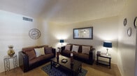 Located at 4601 E Skyline Dr in Tucson, Arizona, this single-story residence offers a well-organized layout with a variety of functional living spaces. The living room serves as the heart of the home, featuring textured ceilings, warm neutral walls, and plush carpeted flooring. A patio door with shuttered blinds allows natural light to filter in, creating a bright and welcoming atmosphere. Adjacent to the living area is a dedicated dining space equipped with a ceiling fan and light fixture, providing a comfortable setting for everyday meals. The galley-style kitchen is equipped with wood cabinetry, a double sink, standard appliances including a refrigerator and range, and benefits from a skylight overhead that enhances the sense of openness. Wood-look flooring adds a practical touch to this area. The bedroom is a quiet, carpeted retreat featuring shuttered windows that invite soft natural light, while the connected bathroom includes a vanity with dark countertops, a large mirror, and wood-look flooring. Throughout the home, textured ceilings are a consistent architectural element, and the overall layout reflects a practical single-floor design suited for comfortable everyday living in the Tucson foothills.