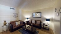 Located at 4601 E Skyline Dr in Tucson, Arizona, this single-story residence offers a well-organized layout with a variety of functional living spaces. The living room serves as the heart of the home, featuring textured ceilings, warm neutral walls, and plush carpeted flooring. A patio door with shuttered blinds allows natural light to filter in, creating a bright and welcoming atmosphere. Adjacent to the living area is a dedicated dining space equipped with a ceiling fan and light fixture, providing a comfortable setting for everyday meals. The galley-style kitchen is equipped with wood cabinetry, a double sink, standard appliances including a refrigerator and range, and benefits from a skylight overhead that enhances the sense of openness. Wood-look flooring adds a practical touch to this area. The bedroom is a quiet, carpeted retreat featuring shuttered windows that invite soft natural light, while the connected bathroom includes a vanity with dark countertops, a large mirror, and wood-look flooring. Throughout the home, textured ceilings are a consistent architectural element, and the overall layout reflects a practical single-floor design suited for comfortable everyday living in the Tucson foothills.