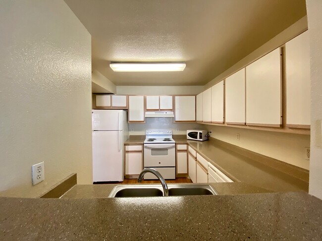 View of kitchen from dining room - Georgetown Place Apartments