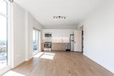 Located at 331 Baldwin Ave in Jersey City, NJ, this modern single-floor residence offers a thoughtfully designed layout with clean, contemporary finishes throughout. The standout feature of the living area is its expansive floor-to-ceiling windows, which wrap around a curved corner to deliver sweeping panoramic views of the Jersey City skyline and surrounding neighborhoods. Abundant natural light pours in throughout the day, illuminating the warm, light-toned hardwood flooring that extends seamlessly through every room.

The open-concept kitchen is outfitted with a combination of white upper cabinetry and warm wood-toned lower cabinets, a white subway tile backsplash, stainless steel appliances including a full-size refrigerator and dishwasher, and a single-basin sink — providing both functionality and modern aesthetic appeal. The kitchen flows directly into the living area, creating an open and airy environment ideal for everyday living.

A well-proportioned hallway connects the living spaces to the private rooms, each featuring crisp white walls, hardwood flooring, and generous closet storage with built-in shelving and hanging rods. The clean, minimalist design ethos is consistent throughout, with white trim, neutral tones, and recessed lighting contributing to a bright and polished ambiance. The overall layout is efficient, well-lit, and finished to a high modern standard.