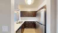 Located at 8601 Glenoaks Blvd in Sun Valley, Los Angeles, this well-appointed one-bedroom, one-bathroom unit offers a thoughtfully designed single-floor layout. The kitchen is a standout feature, showcasing rich dark-wood cabinetry, stone-look countertops, a deep stainless steel sink, and a full suite of stainless steel appliances including a refrigerator, range, and microwave. Light wood-style flooring runs throughout the kitchen and connects seamlessly to the open living area. The spacious living room is bathed in natural light, enhanced by a ceiling fan and sliding glass doors that lead to a private balcony with outdoor views — ideal for everyday relaxation. The generously sized bedroom features plush carpeting, a textured ceiling, a ceiling fan, and a large window with vertical blinds that allow for ample natural light. Two closets provide excellent storage throughout the unit. The bathroom is clean and functional, complete with a shower-tub combo, a vanity with dark wood cabinetry, a white countertop sink, and a mirrored medicine cabinet. Neutral wall tones and consistent finishes throughout the unit create a cohesive and comfortable living environment.