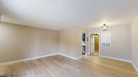 Located at 4162–4168 Treadway Rd in Beaumont, TX, this 1-bedroom, 1-bathroom unit offers a thoughtfully designed single-floor layout with modern updates throughout. Light wood-look flooring runs continuously across the space, complementing warm neutral wall tones and crisp white trim for a clean, cohesive aesthetic.

The open living room is bright and inviting, anchored by a stylish flush-mount chandelier and a full-width sliding glass door that opens to a private balcony overlooking a landscaped exterior — filling the room with natural light and outdoor views.

The galley-style kitchen is well-equipped with gray shaker cabinetry, white quartz countertops, stainless steel appliances including a refrigerator, range, and microwave, and a single-basin sink — delivering a functional and contemporary cooking space.

The spacious primary bedroom is a comfortable retreat, featuring a ceiling fan with light fixture, a natural light-filled window with outdoor views, and convenient access to a dedicated closet and laundry area. The full bathroom is finished with a tub/shower combo, matte black fixtures, and gray upper cabinetry for added storage. Clean lines and modern hardware carry the updated style throughout the entire unit.