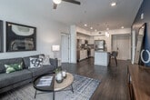 Located at 3661 Main St in Riverside, California, this single-floor residence showcases a thoughtfully designed open-concept layout with contemporary finishes throughout. The living area is bright and inviting, with multiple windows that allow generous natural light to fill the space, complemented by wood-style flooring, a ceiling fan, and a seamless flow into the dining and kitchen areas.

The kitchen is a standout feature, outfitted with crisp white cabinetry, a striking black-and-white mosaic tile backsplash, stainless steel appliances including a gas range, microwave, and refrigerator, and a large center island with pendant lighting and bar seating — ideal for both cooking and casual dining.

The bedrooms offer comfortable retreats, each with plush carpeting, ceiling fans, and large windows that bring in natural light. One bedroom features a bold blue accent wall paired with a built-in desk area, while another offers a serene, neutral palette with elegant drapery.

Two well-appointed bathrooms serve the residence. One features a glass-enclosed walk-in shower with tile surround and a bold blue accent wall, while the second includes a full soaking tub and shower combination with textured tile detailing. Both bathrooms are finished with white vanity cabinetry and large-format tile flooring, creating a clean, modern aesthetic throughout.