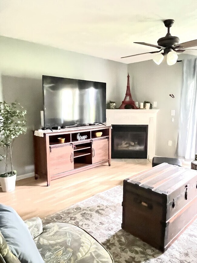 Living room with smart TV, decorative fireplace and walk out patio. - 12584 Tennyson Ln
