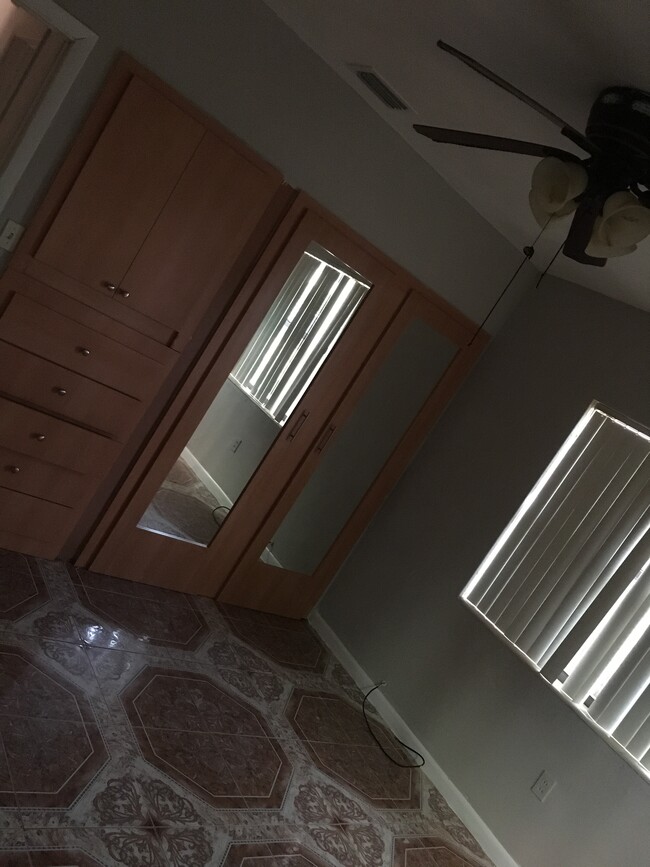 Bedroom with glass closet doors. - 1583 NE 109th St