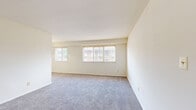 Located at 2600 W Patapsco Ave in Baltimore, MD, this single-floor unit offers four bedrooms, one bathroom, and a kitchen within a compact, efficiently designed layout. The space features consistent neutral-toned carpeting throughout the living and bedroom areas, complemented by clean white walls that create a bright, uniform aesthetic. The expansive primary bedroom provides generous room for furnishings and includes closet storage, while the additional bedrooms each offer comfortable proportions, built-in closets, and windows that invite natural light. The galley-style kitchen is outfitted with warm wood cabinetry, gray laminate countertops, a stainless steel sink, and tile flooring, providing a functional cooking space with ample cabinet storage on both sides. A door at the end of the kitchen leads to additional storage or utility access. The full bathroom features classic white subway tile wainscoting, small-format floor tile, and a full tub-shower combination, maintaining a clean and practical design. Throughout the unit, the layout is straightforward and well-organized, with clear sightlines between rooms. Multiple windows across the unit allow natural light to filter in, contributing to an open and airy atmosphere.